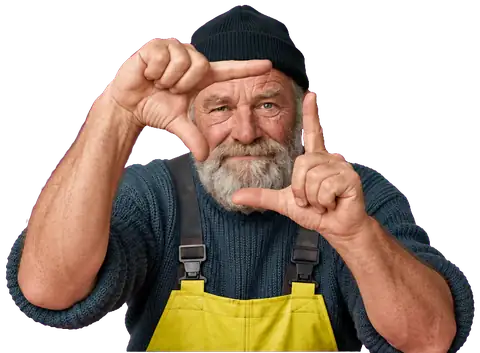 Bob van Brandaan, vuurtorenwachter met grijze baard, muts en gele waterbroek, die met zijn handen een kader maakt